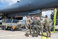 Airmen work on the flightline next to a B-1B Lancer