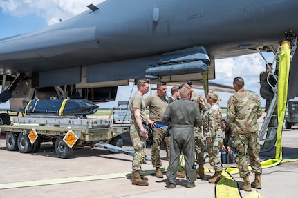 Airmen work on the flightline next to a B-1B Lancer