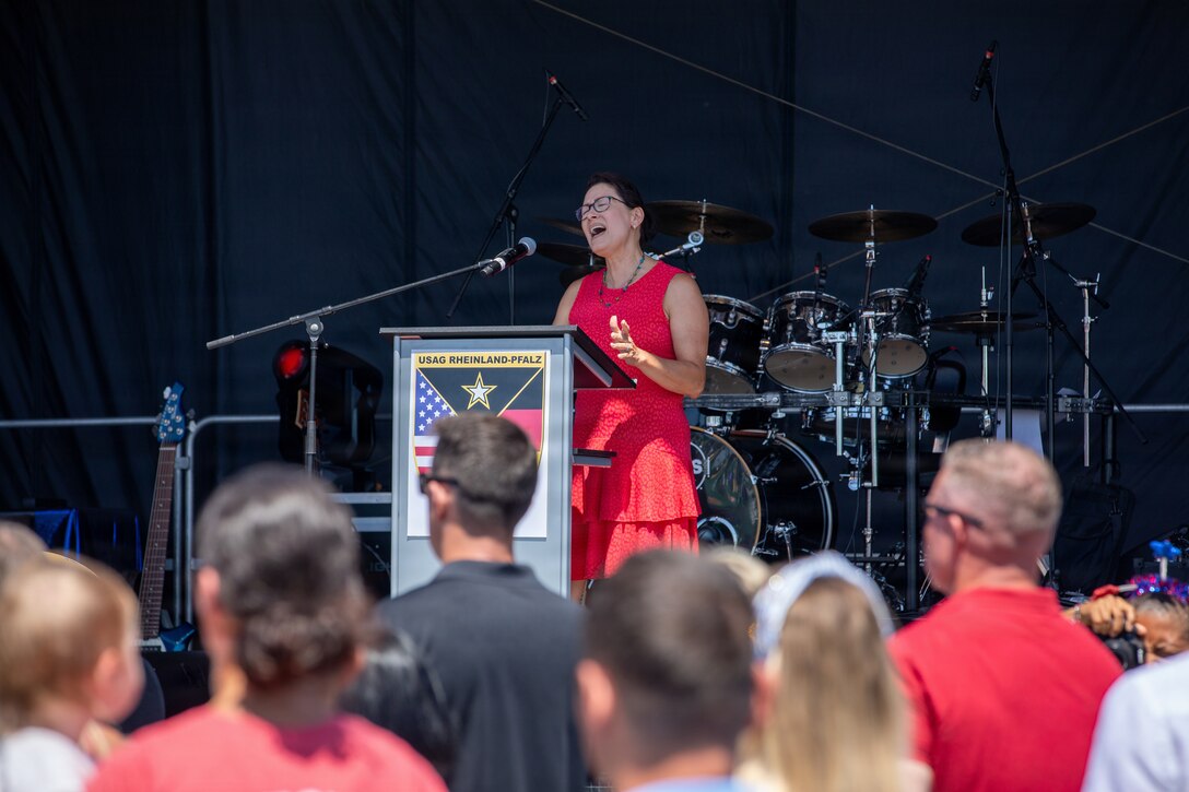 A volunteer, Monica Alent, sings the national anthem during the German-American Friendship Festival in Baumholder, Germany, July 4, 2026. The performance marked the opening of the Independence Day celebration and reflected the shared values and longstanding partnership between the United States and Germany. (U.S. Army photo by Pfc. Robert Palmer)
