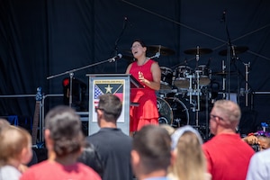 A volunteer, Monica Alent, sings the national anthem during the German-American Friendship Festival in Baumholder, Germany, July 4, 2026. The performance marked the opening of the Independence Day celebration and reflected the shared values and longstanding partnership between the United States and Germany. (U.S. Army photo by Pfc. Robert Palmer)