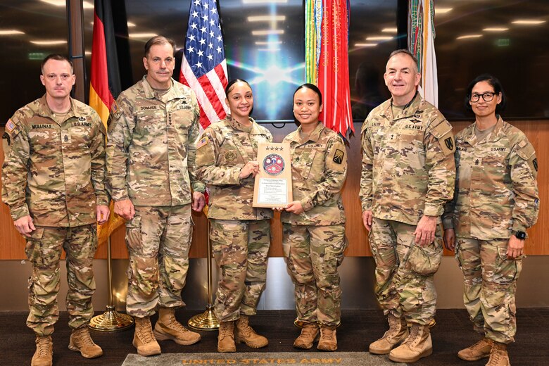 From left, Col. Michael S. Mullinax, U.S. Army Europe and Africa Deputy Chief of Staff, G-4; Gen. Christopher Donahue, commanding general of U.S. Army Europe and Africa; Spc. Coston; Spc. Ista; Command Sgt. Maj. Giancarlo F. Lalor, USAREUR-AF senior enlisted leader; and Command Sgt. Maj. Malave pose for a photo after the 16th Sustainment Brigade Property Book Office (PBO) was presented a Logistics Excellence Award in Wiesbaden, Germany, June 12, 2026. The 16th Sustainment Brigade PBO was recognized as a theater-level winner in the fiscal year 2025 Chief of Staff of the Army's Logistics Excellence Awards program for their outstanding contributions to Army readiness and superior supply discipline. (U.S. Army photo by Mr. Nathaniel Petraitis)