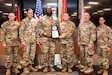 From left, Command Sgt. Maj. Mullinax; Gen. Christopher Donahue, commanding general of U.S. Army Europe and Africa; Staff Sgt. Walton; Staff Sgt. Whitfield; Command Sgt. Maj. Giancarlo F. Lalor, USAREUR-AF senior enlisted leader; and Command Sgt. Maj. Malave, pose for a photo after the 7th Army Training Command Property Book Office was presented the Army Award for Maintenance Excellence 