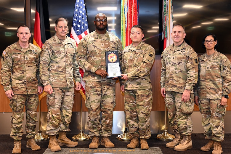 From left, Command Sgt. Maj. Mullinax; Gen. Christopher Donahue, commanding general of U.S. Army Europe and Africa; Staff Sgt. Walton; Staff Sgt. Whitfield; Command Sgt. Maj. Giancarlo F. Lalor, USAREUR-AF senior enlisted leader; and Command Sgt. Maj. Malave, pose for a photo after the 7th Army Training Command Property Book Office was presented the Army Award for Maintenance Excellence "Best of the Best" Award during a ceremony in Wiesbaden, Germany, June 12, 2026. The 7th ATC PBO was recognized as the top maintenance unit in the entire U.S. Army for fiscal year 2025, a testament to their dedication to readiness and excellence. (U.S. Army photo by Mr. Nathaniel Petraitis)