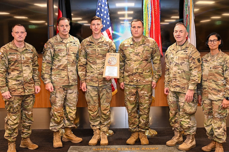 From left, Command Sgt. Maj. Mullinax; Gen. Christopher Donahue, commanding general of U.S. Army Europe and Africa; Staff Sgt. Timm; Sgt. Colon; Command Sgt. Maj. Giancarlo F. Lalor, USAREUR-AF senior enlisted leader; and Command Sgt. Maj. Malave, pose for a photo after the 240th Combat Sustainment Company was presented a Logistics Excellence Award in the Supply Support Activity category in Wiesbaden, Germany, June 12, 2026. The unit was recognized as a theater-level winner in the fiscal year 2025 Chief of Staff of the Army's Logistics Excellence Awards program. (U.S. Army photo by Mr. Nathaniel Petraitis)