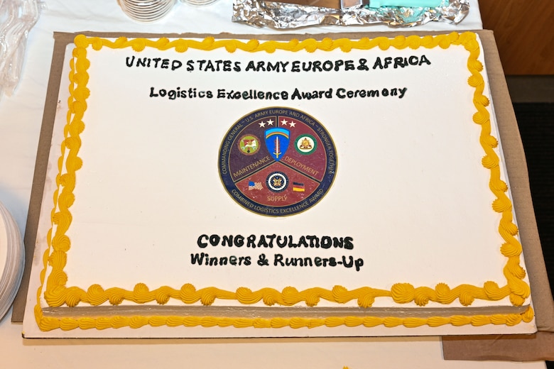 A cake celebrating the winners and runners-up of the U.S. Army Europe and Africa Logistics Excellence Award program is displayed during a ceremony in Wiesbaden, Germany, June 12, 2026. The event honored the top logisticians, maintenance professionals, and environmental stewards whose efforts are a cornerstone of readiness and interoperability with NATO Allies and partners. (U.S. Army photo by Mr. Nathaniel Petraitis)