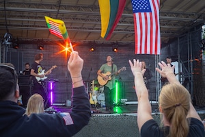 A Lithuanian band, the Michael Frishman Show, performs on stage for U.S., Lithuanian and German service members during a celebration at Pabradė Training Area, Lithuania, July 3, 2026. Service members waved Lithuanian and U.S. flags from the crowd as the concert was held in part of a day of celebration  of both the 250th anniversary of the United States’ independence on July 4th and Lithuanian Statehood Day, observed July 6 in commemoration of the 1253 coronation of King Mindaugas. V Corps is the U.S. Army's only forward-deployed corps, serving as the senior tactical headquarters for Army forces in Eastern Europe to deter conflict and provide combat-ready forces alongside our NATO Allies. V Corps is operationalizing and expanding the Eastern Flank Deterrence Initiative with Allies, rapidly integrating emerging technologies into training and tactical plans.