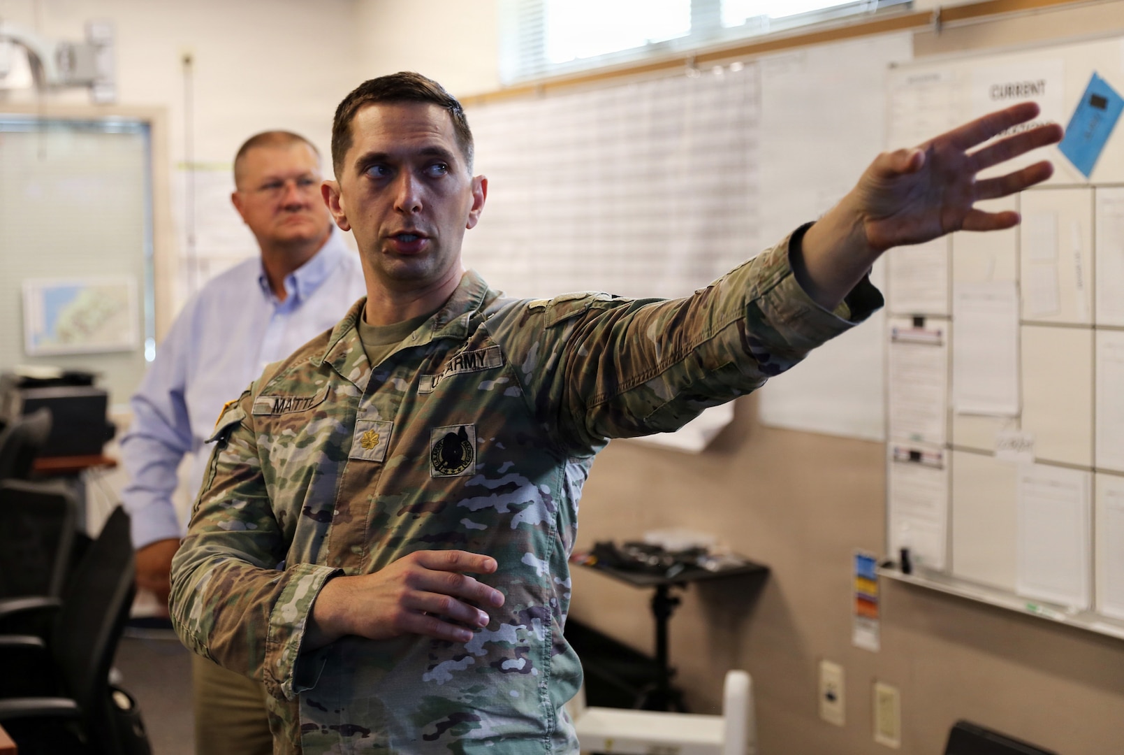 Maj. Pierre Matte, Joint Operations Center Battle Manager, updates Ken Flowers, National Guard Bureau chief information officer/J6’s chief tech officer and division chief, J65 National Guard Bureau and Ed Pruitt, Maven Systems on the National Guard support to Seattle’s FIFA World Cup 2026 matches, June 26, 2026, at the Joint Operations Center, Camp Murray, Washington.