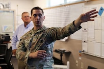 Maj. Pierre Matte, Joint Operations Center Battle Manager, updates Ken Flowers, National Guard Bureau chief information officer/J6’s chief tech officer and division chief, J65 National Guard Bureau on the National Guard support to Seattle’s FIFA World Cup 2026 matches, June 26, 2026 at the Joint Operations Center, Camp Murray, Washington.