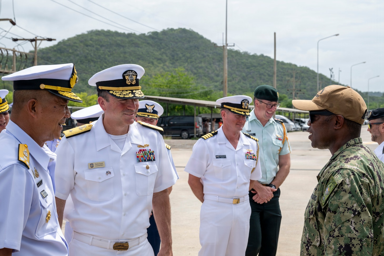 U.S. Navy Rear Adm. Kyle Gantt, deputy commander, U.S. 7th Fleet, and Royal Thai Navy Vice Adm. Songkrit Chatngern, deputy commander in chief of the Royal Thai Fleet, talk with a U.S. Coast Guardsman during the opening ceremony of exercise Cooperation Afloat Readiness and Training (CARAT) Thailand 2026, July 6, 2026, at Laem Tian Pier.