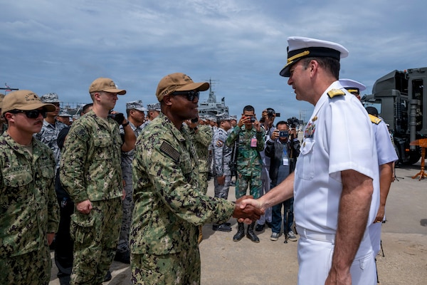 U.S. Navy Rear Adm. Kyle Gantt, deputy commander, U.S. 7th Fleet, greets U.S. Coast Guard Lt. Cmdr. Patrick Dixon, commanding officer of the Sentinel-class fast response cutter USCGC Charles Moulthrope (WPC 1141), during the opening ceremony of exercise Cooperation Afloat Readiness and Training (CARAT) Thailand 2026, July 6, 2026, at Laem Tian Pier.