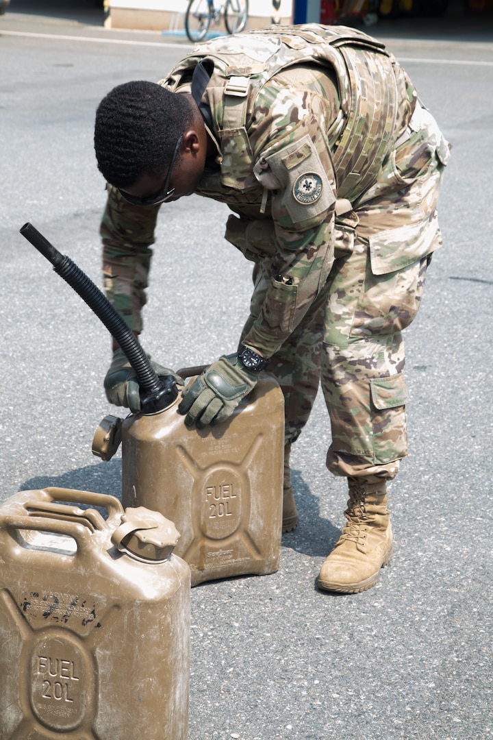 A U.S. Soldier, assigned to the 2nd Squadron, 2d Cavalry Regiment, attaches a nozzle to a fuel can in Poland, June 1, 2018.