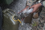 Lance Cpl. Victor Njoroge, a bulk fuel specialist with Combat Logistics Battalion 31, fills a fuel can during training at Naval Base Guam.