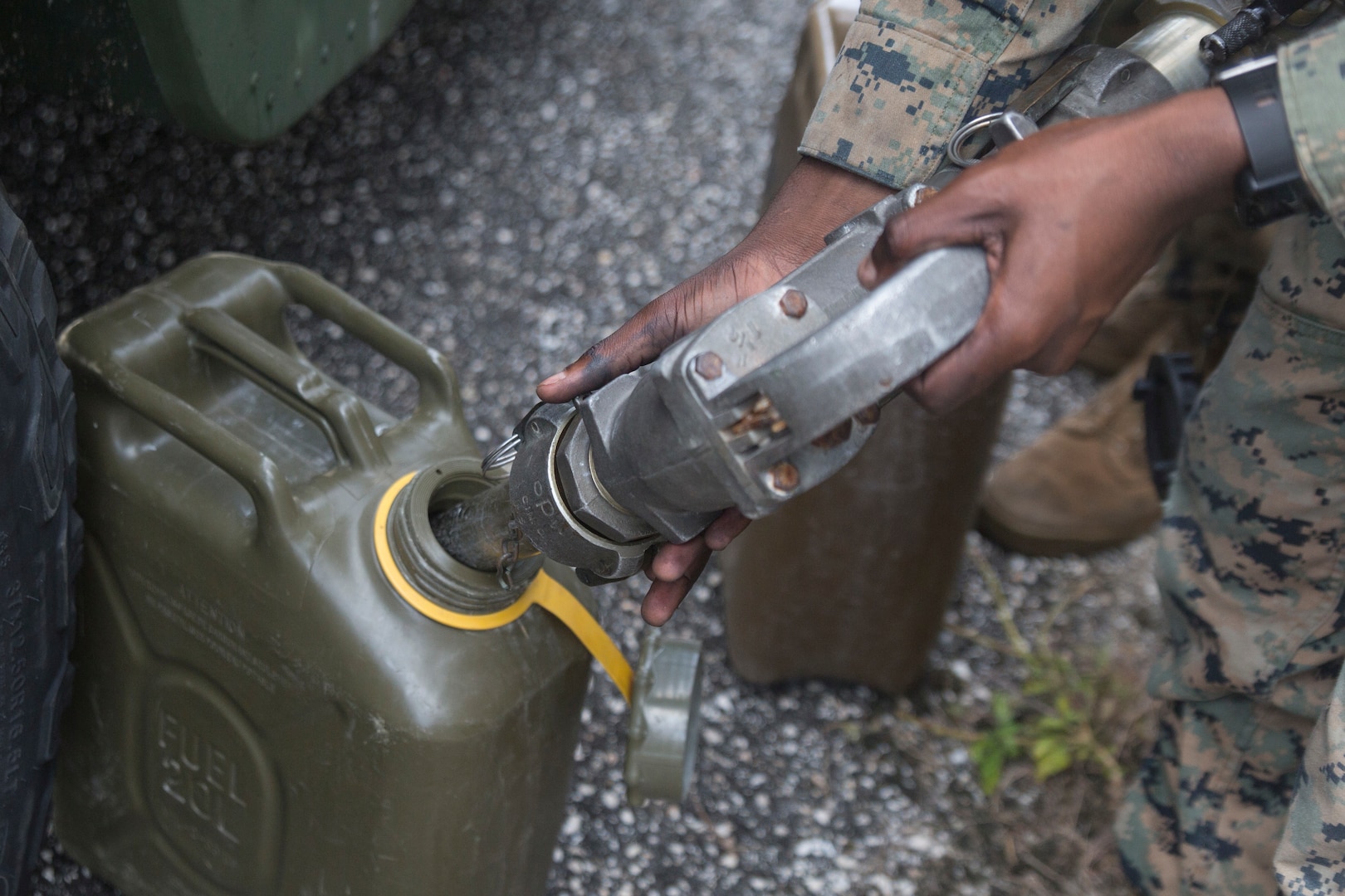 Lance Cpl. Victor Njoroge, a bulk fuel specialist with Combat Logistics Battalion 31, fills a fuel can during training at Naval Base Guam.