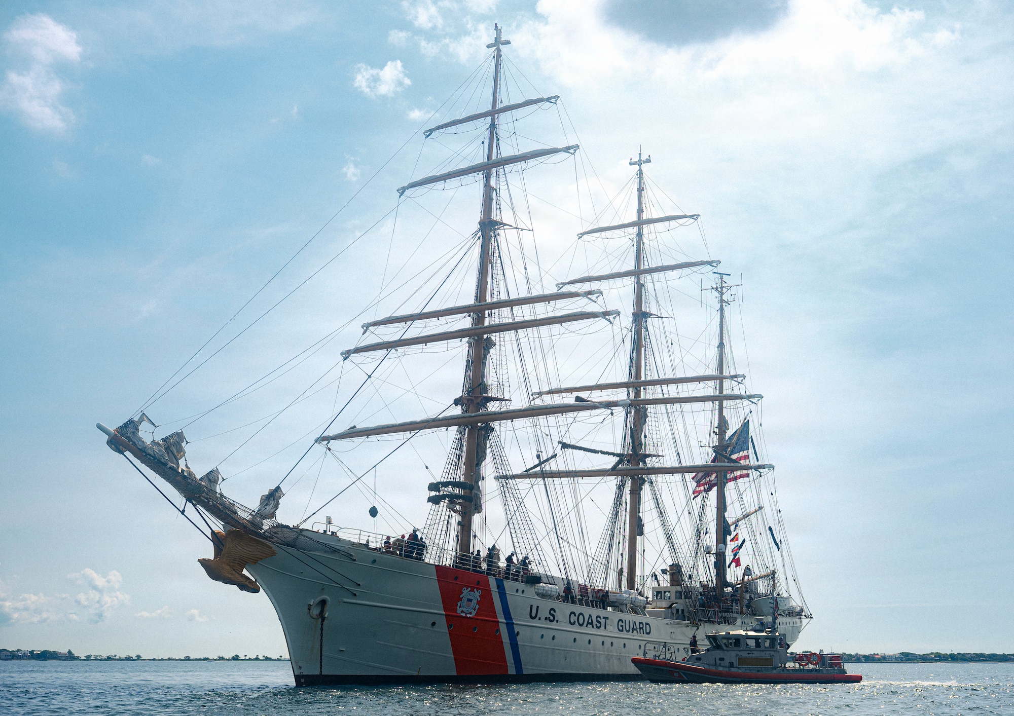 A boat sails across the Charleston Harbor.