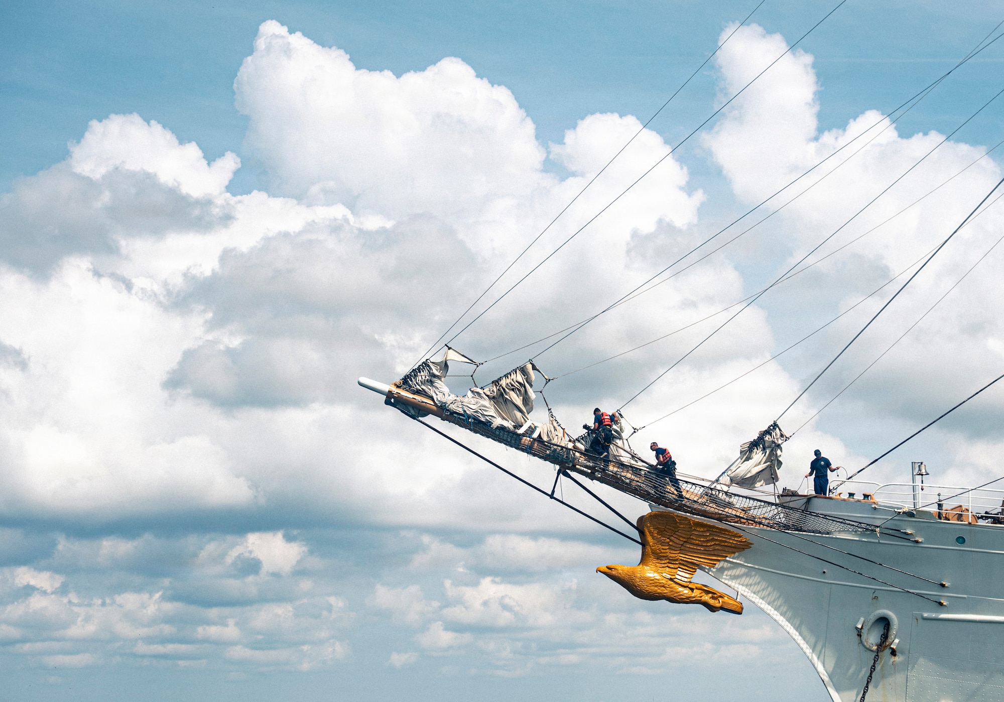 U.S. Coast Guardsmen perform their work duties on a boat.