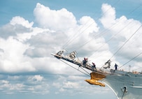 U.S. Coast Guardsmen perform their work duties on a boat.