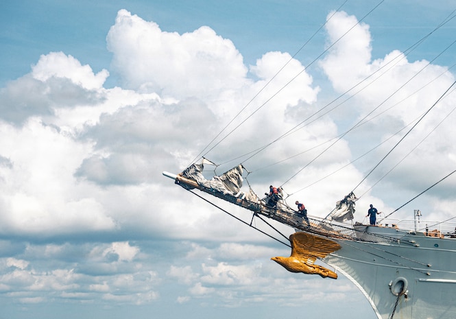 U.S. Coast Guardsmen perform their work duties on a boat.
