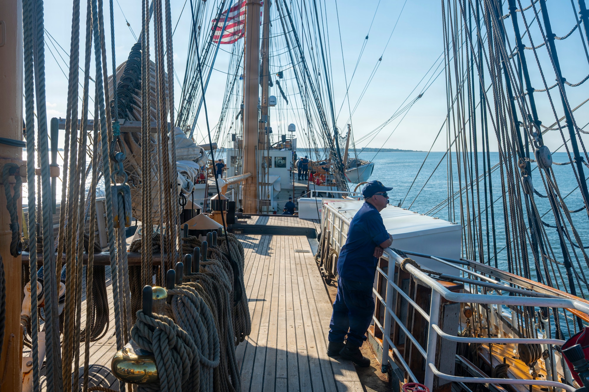 A U.S. Coast Guardsman stands on a boat.