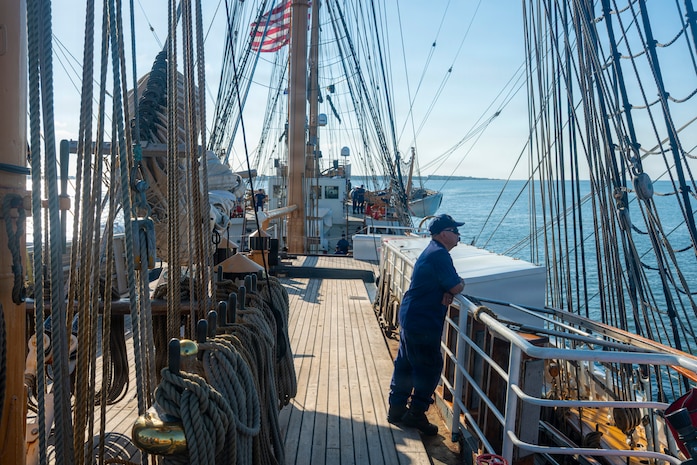 A U.S. Coast Guardsman stands on a boat.