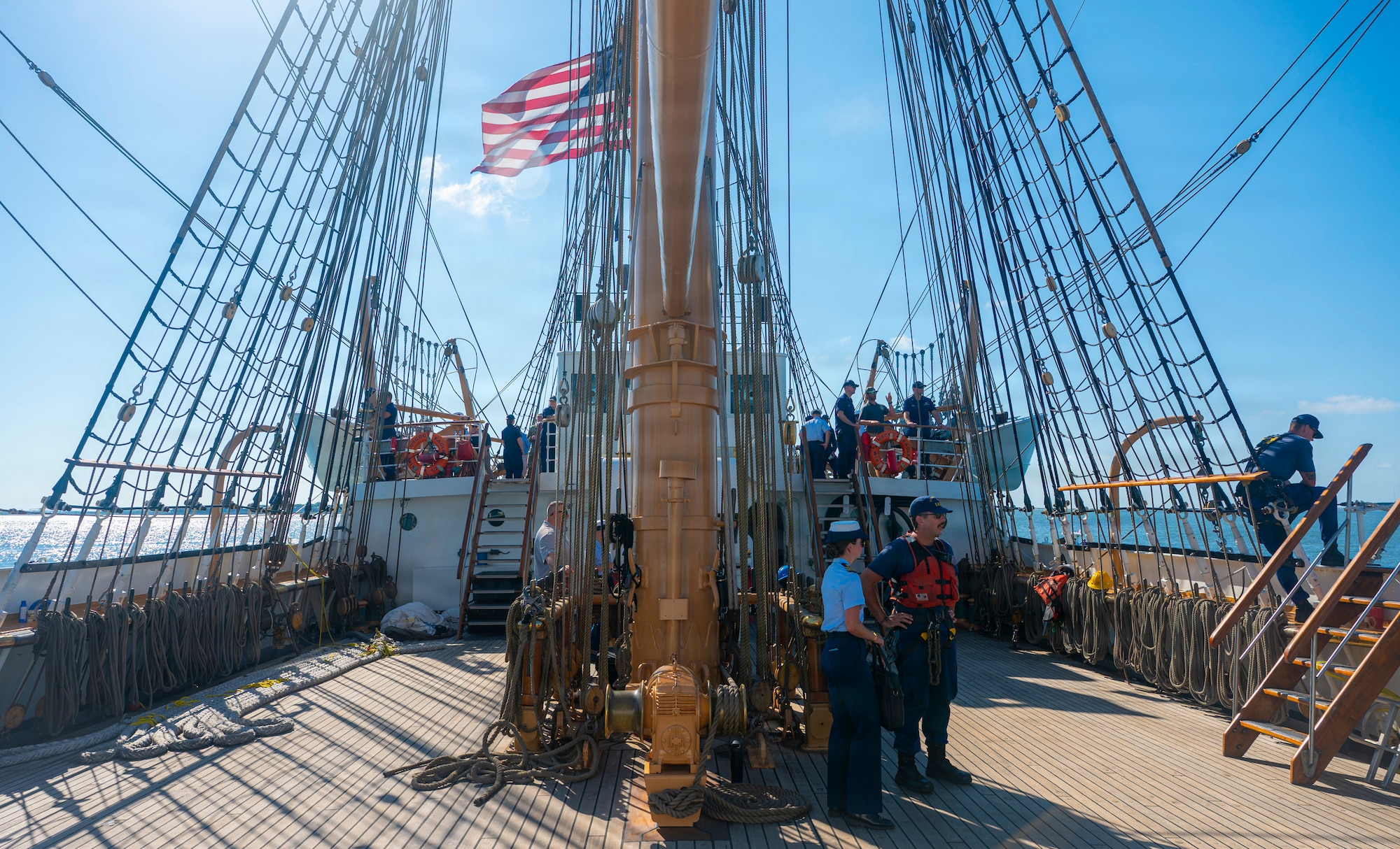 U.S. Coast Guardsmen converse with local residents on a boat.