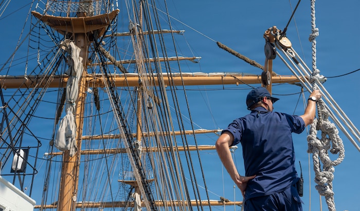 A U.S. Coast Guardsman stands on a boat