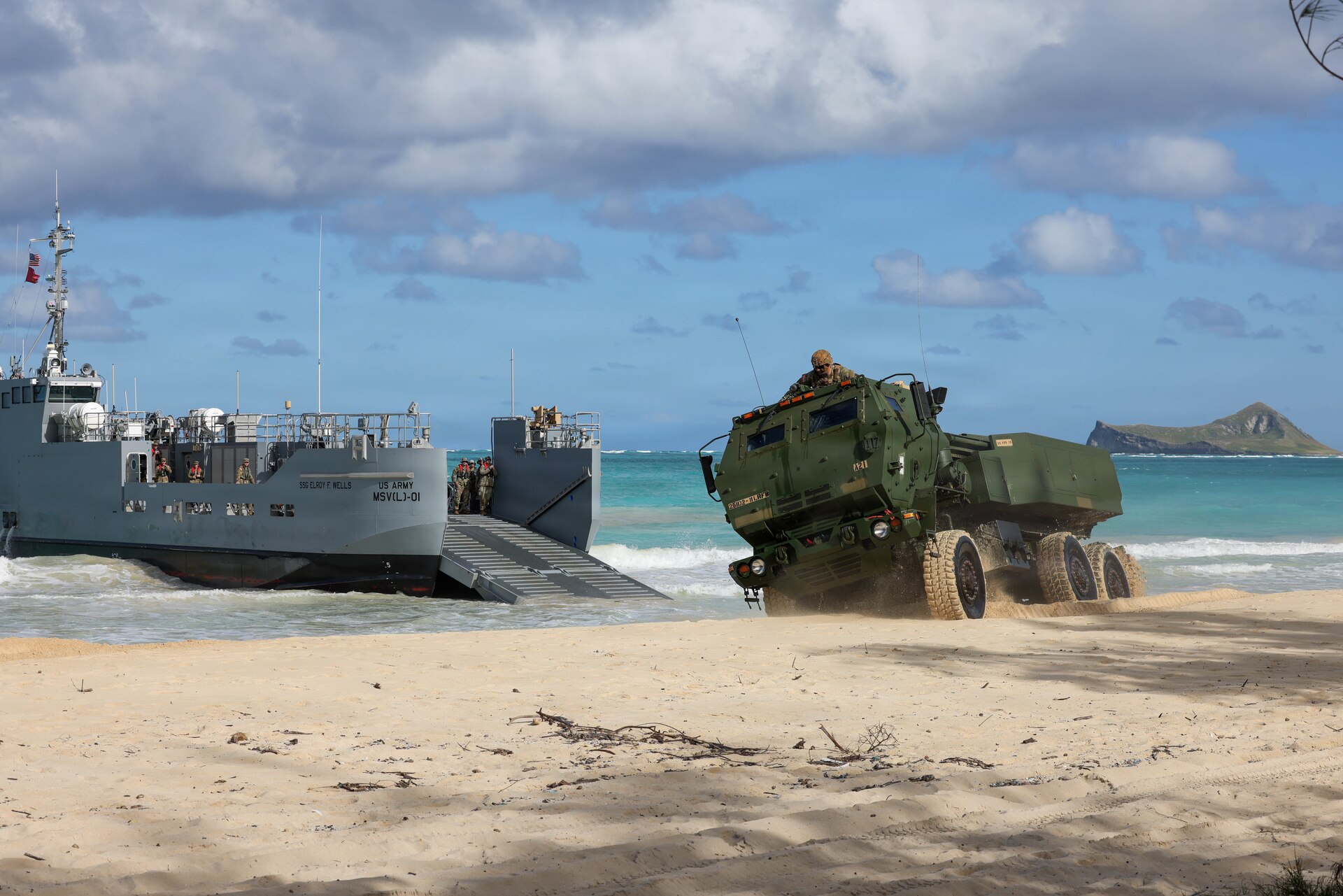 U.S. Soldiers assigned to the 7th Transportation Brigade execute a littoral rapid infiltration operation transporting High Mobility Artillery Rocket Systems from 2nd Battalion, 11th Field Artillery Regiment, 25th Infantry Division at Bellows Air Force Station, Hawaii, Feb. 25, 2026.