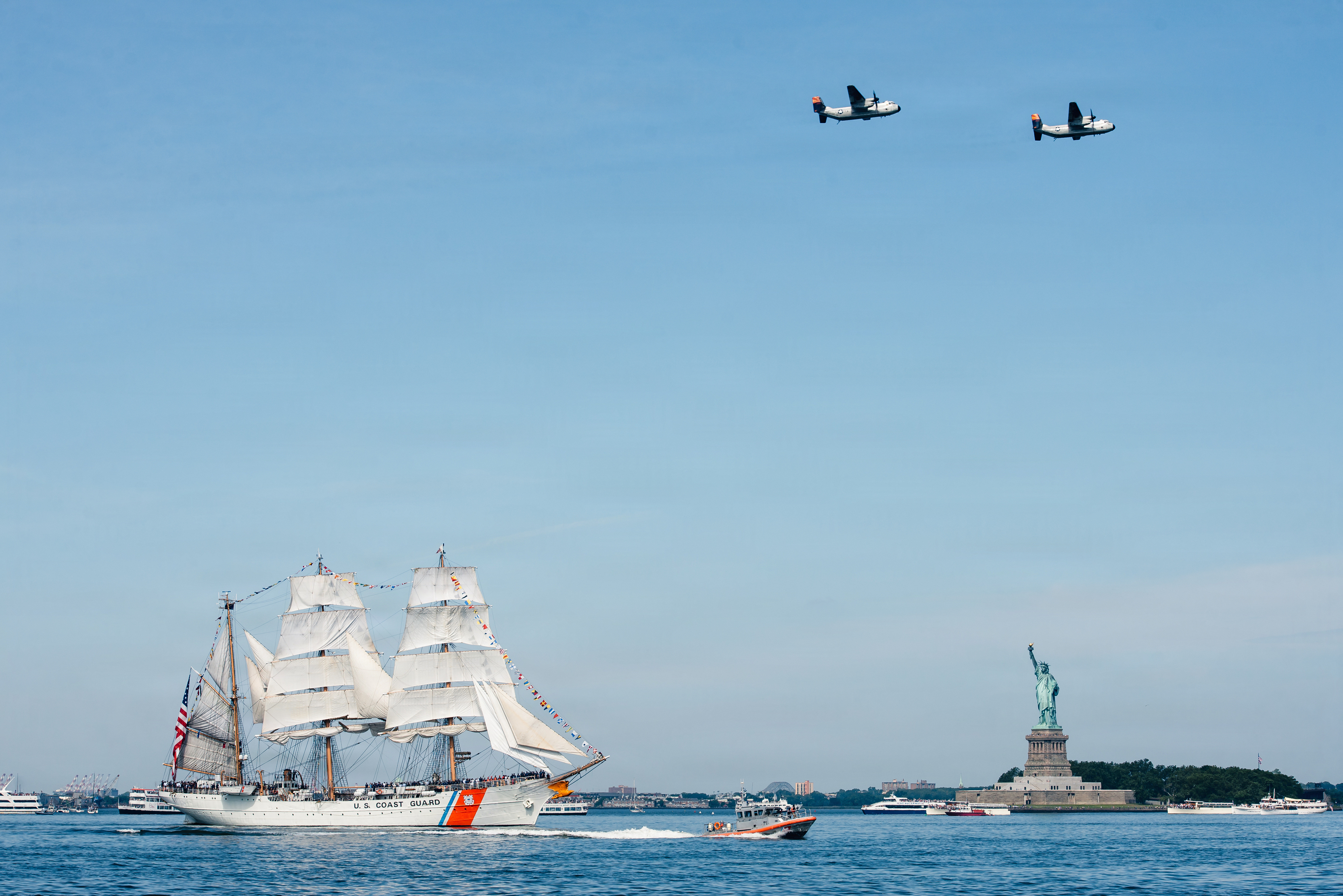 Coast Guard Barque Eagle passing the Statue of Liberty during the 2026 America 250 maritime celebration