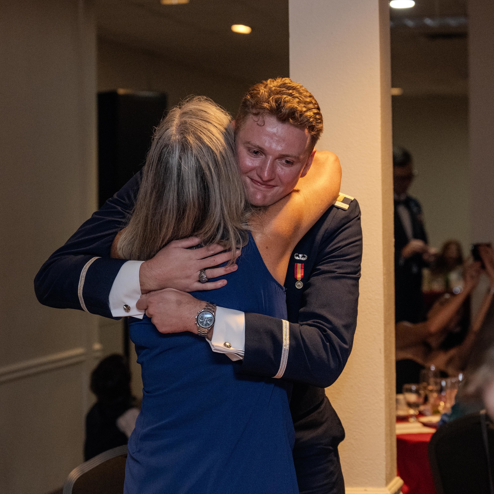 U.S. Air Force 2nd Lt. Jonathon McGrath, 47th Student Squadron student pilot, hugs their loved one during the graduation ceremony for class 26-13 at Laughlin Air Force Base, Texas, July 1, 2026. Twenty-two U.S. Air Force officers were awarded their silver wings during the ceremony, symbolizing their completion of the Undergraduate Pilot Training program. (U.S. Air Force photo by Airman 1st Class Harrison Sullivan)