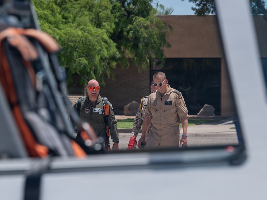 U.S. Air Force Brig. Gen. David Berkland, 56th Fighter Wing commander, left, and German Air Force Lt. Col. Tom Doberschuetz, 3rd German Air Force Training Squadron commander, step to a Grob 120TP trainer aircraft as part of a leadership engagement at Luke Air Force Base, Arizona, July 1, 2026.