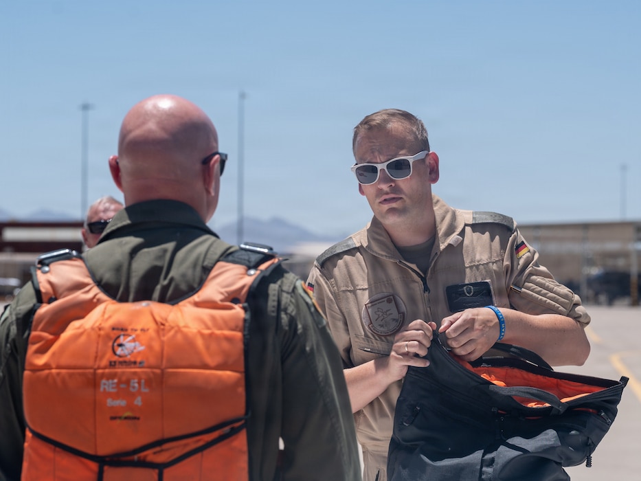 U.S. Air Force Brig. Gen. David Berkland, 56th Fighter Wing commander, left, and German Air Force Lt. Col. Tom Doberschuetz, 3rd German Air Force Training Squadron commander, speak on a flightline as part of a leadership engagement at Luke Air Force Base, Arizona, July 1, 2026.