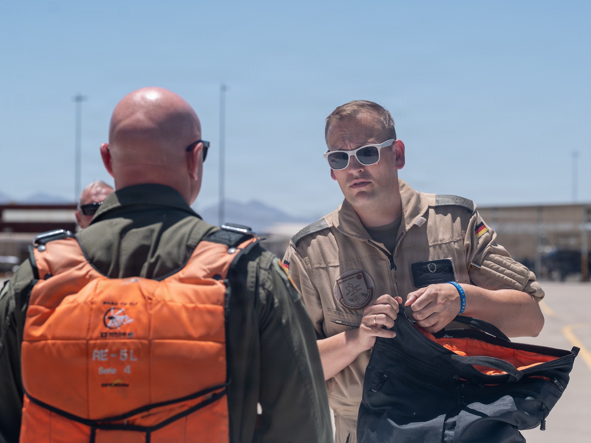 U.S. Air Force Brig. Gen. David Berkland, 56th Fighter Wing commander, left, and German Air Force Lt. Col. Tom Doberschuetz, 3rd German Air Force Training Squadron commander, speak on a flightline as part of a leadership engagement at Luke Air Force Base, Arizona, July 1, 2026.