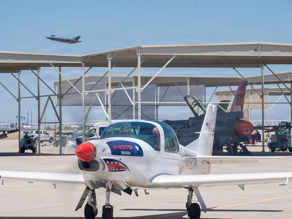 U.S. Air Force Brig. Gen. David Berkland, 56th Fighter Wing commander, right, and German Air Force Lt. Col. Tom Doberschuetz, 3rd German Air Force Training Squadron commander, prepare for takeoff in a Grob 120TP trainer aircraft as part of a leadership engagement at Luke Air Force Base, Arizona, July 1, 2026.