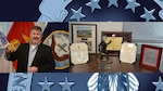 Mark Brewer is posed with his retirement awards.