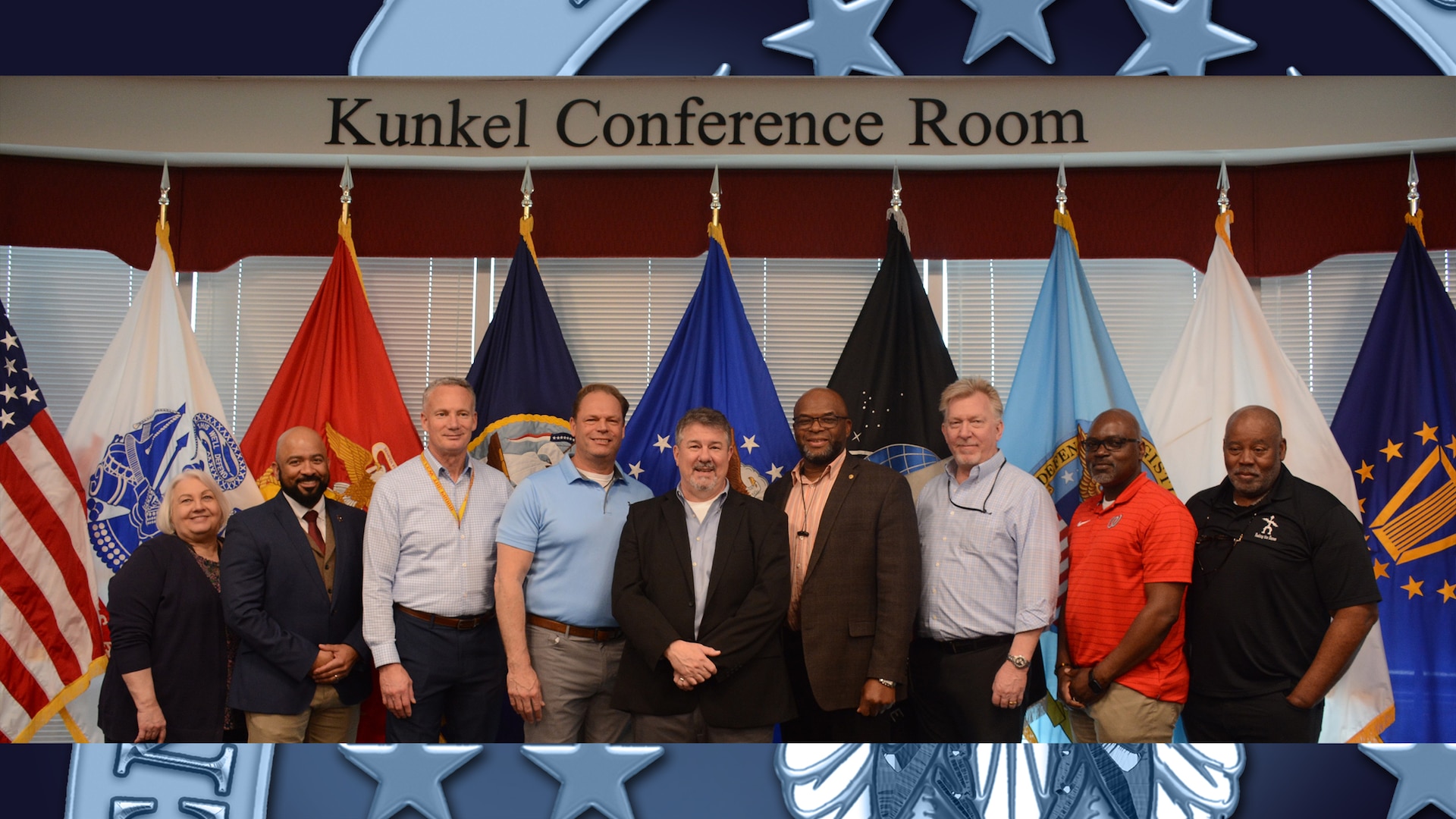 Large group of people pose for a picture after a retirement ceremony.