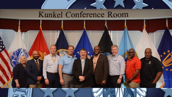 Large group of people pose for a picture after a retirement ceremony.
