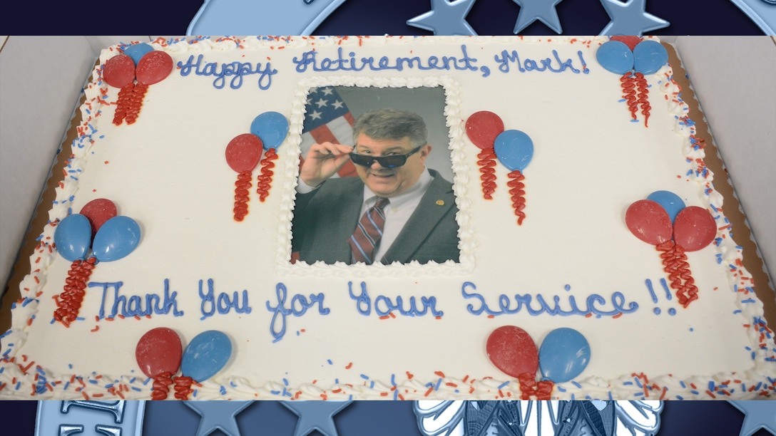 Photo of retiree featured on decorated cake.