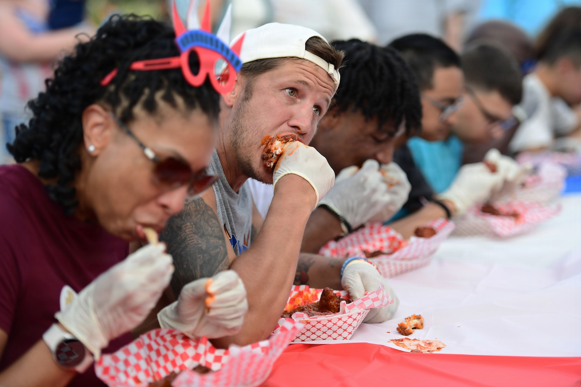 A group of people eat hot wings