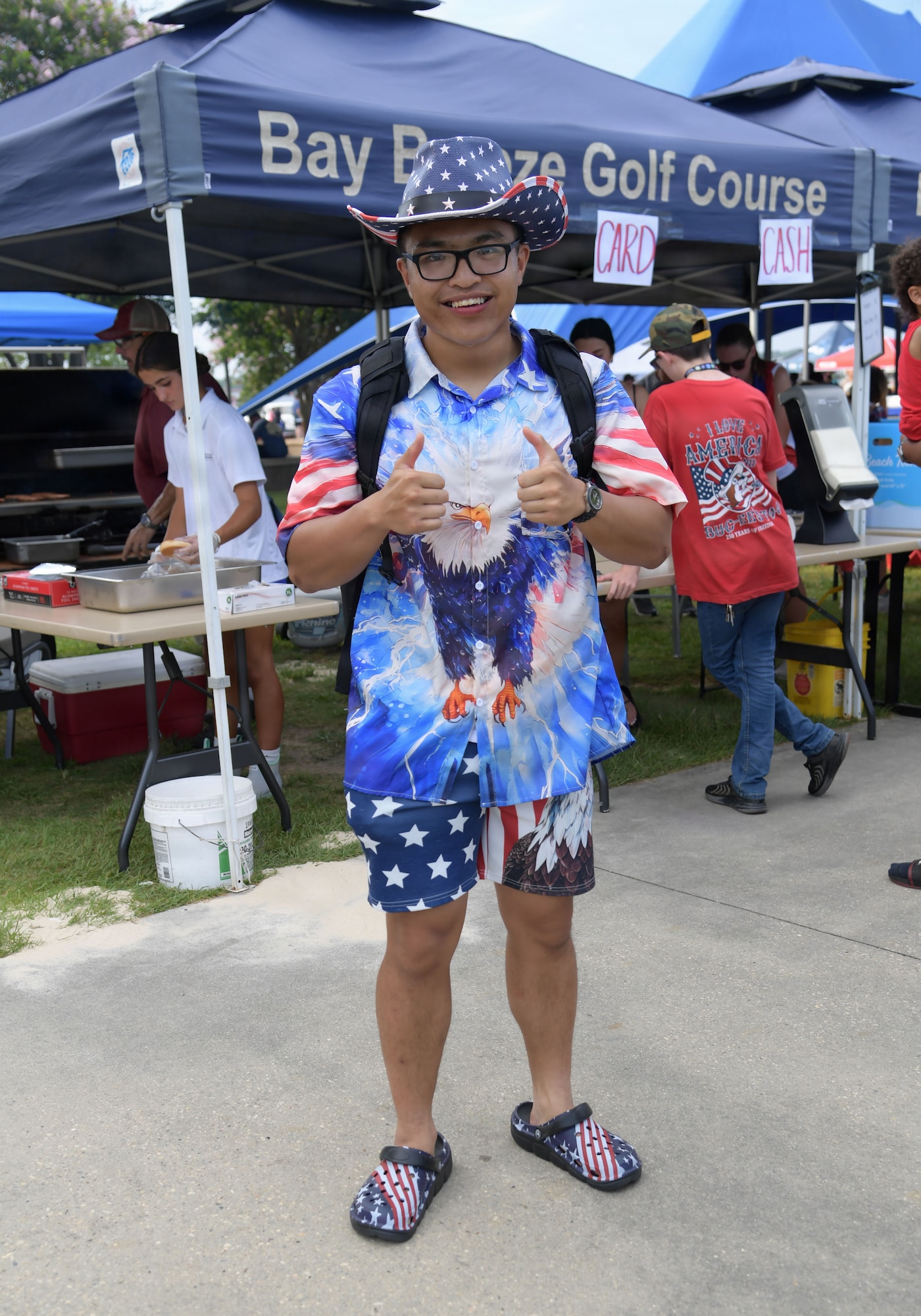 A man poses for a photo while wearing red, white and blue clothing
