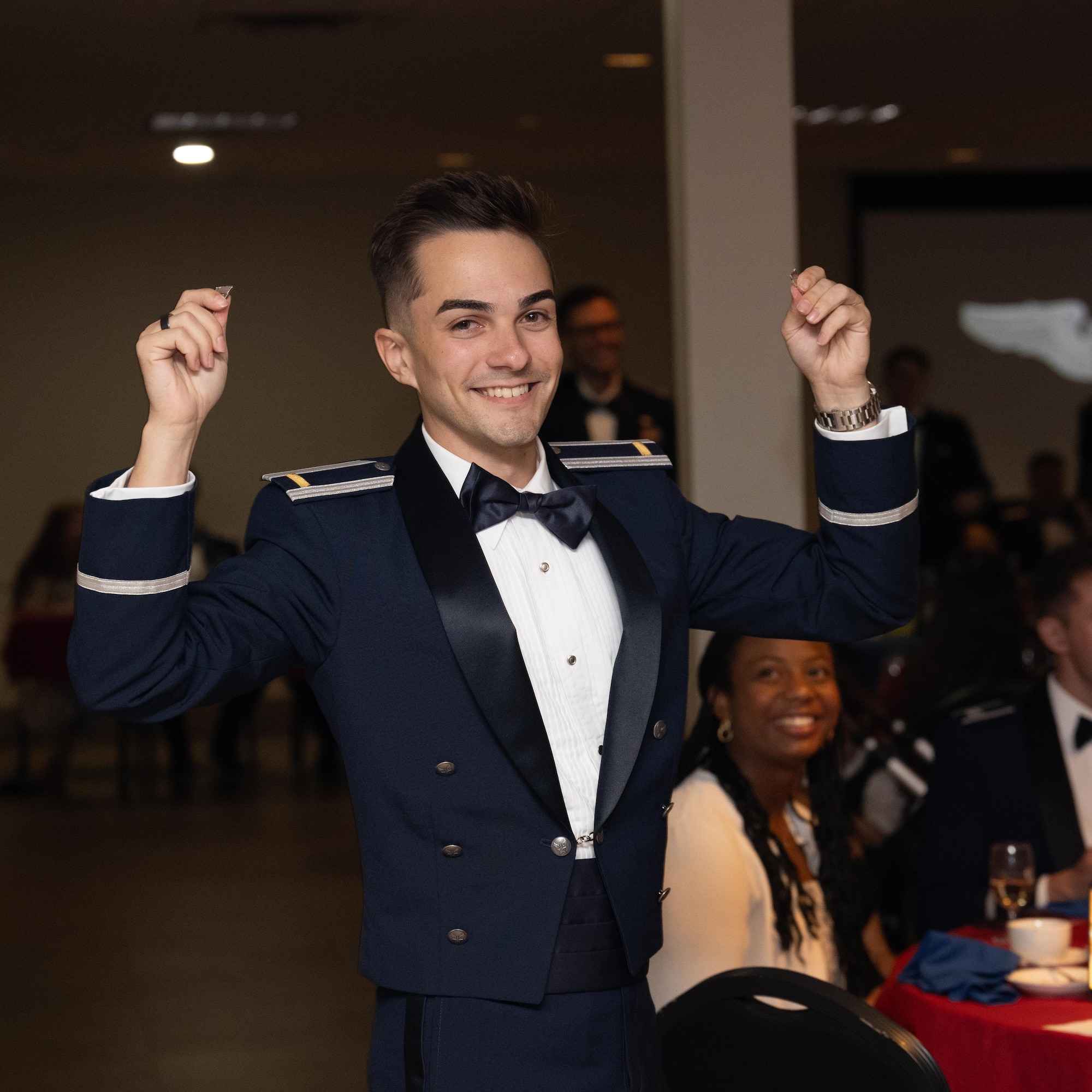 U.S. Air Force 2nd Lt. Aiden Babiarz, 47th Student Squadron student pilot, holds up their broken silver wings during the graduation ceremony for class 26-13 at Laughlin Air Force Base, Texas, July 1, 2026. Twenty-two U.S. Air Force officers were awarded their silver wings during the ceremony, symbolizing their completion of the Undergraduate Pilot Training program. (U.S. Air Force photo by Airman 1st Class Harrison Sullivan)