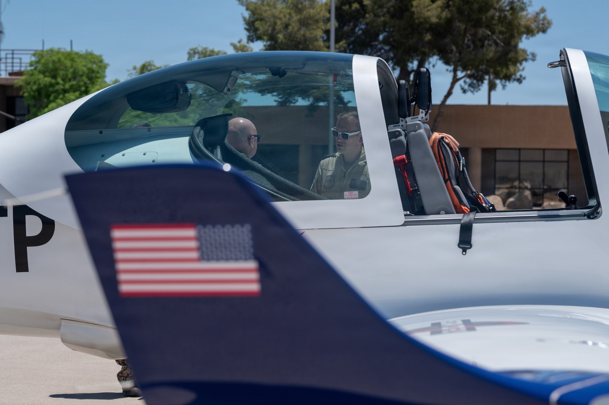 U.S. Air Force Brig. Gen. David Berkland, 56th Fighter Wing commander, left, and German Air Force Lt. Col. Tom Doberschuetz, 3rd German Air Force Training Squadron commander, speak on the flightline in front of a Grob 120TP trainer aircraft as part of a leadership engagement at Luke Air Force Base, Arizona, July 1, 2026.