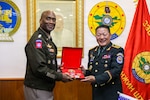Mongolian Lt. Gen. Sunrev Ganbyamba presents a gift to U.S. Army Gen. Xavier T. Brunson during a bilateral meeting in Ulaanbaatar, Mongolia.