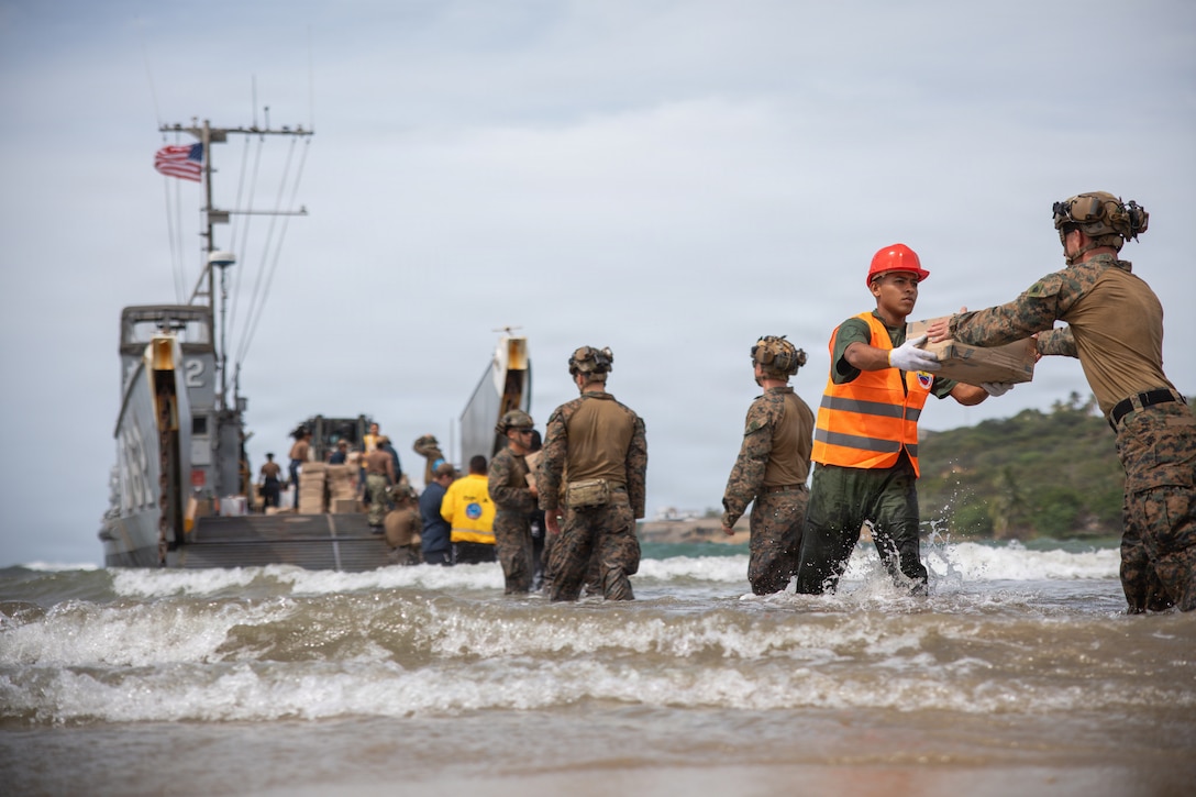 U.S. Marines with 3rd Battalion, 2nd Marine Regiment, Littoral Combat Force-24; U.S. Sailors with San Antonio-class amphibious transport dock USS Fort Lauderdale (LPD 28); and Venezuelan service members, offload supplies from a Landing Craft Utility vessel assigned to the Fort Lauderdale during a supply delivery at La Guaira, Venezuela, June 5, 2026. At the direction of U.S. Southern Command, assigned U.S. military forces are supporting Department of State-led U.S. disaster assistance to the people of Venezuela in the aftermath of the June 24, 2026, earthquakes. (U.S. Marine Corps photo)