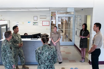 Navy Force Master Chief PatrickPaul “PaP” C. Mangaran, command senior enlisted leader for the Defense Health Agency, second from left, speaks with Hospital Corpsman 3rd Class David South, right, the Assistant Leading Petty Officer for Naval Health Clinic Cherry Point’s Patient Centered Medical Home on Friday, June 26, 2026. Mangaran toured NHCCP for an update on latest development to facilities for patients and staff. NHCCP serves as the keystone of medical readiness for units assigned to Marine Corps Air Station Cherry Point.