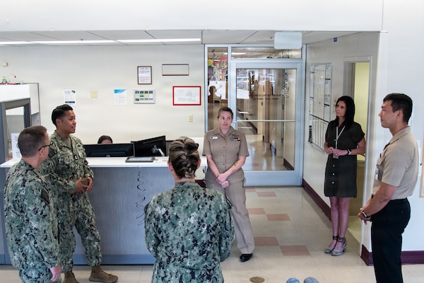 Navy Force Master Chief PatrickPaul “PaP” C. Mangaran, command senior enlisted leader for the Defense Health Agency, second from left, speaks with Hospital Corpsman 3rd Class David South, right, the Assistant Leading Petty Officer for Naval Health Clinic Cherry Point’s Patient Centered Medical Home on Friday, June 26, 2026. Mangaran toured NHCCP for an update on latest development to facilities for patients and staff. NHCCP serves as the keystone of medical readiness for units assigned to Marine Corps Air Station Cherry Point.
