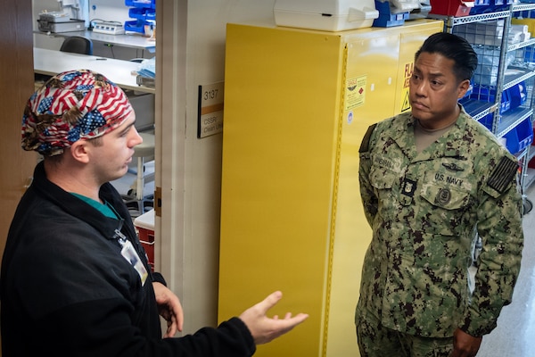 Navy Hospital Corpsman 2nd Class Zachary Roy, left, Leading Petty Officer for Naval Health Clinic Cherry Point’s Directorate of Surgical Services, briefs Navy Force Master Chief PatrickPaul “PaP” C. Mangaran, command senior enlisted leader for the Defense Health Agency, on sterilization procedures at NHCCP on Friday, June 26, 2026.  Mangaran toured NHCCP for an update on latest development to facilities for patients and staff.  NHCCP serves as the keystone of medical readiness for units assigned to Marine Corps Air Station Cherry Point.