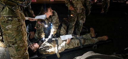 Staff Sgt. Noel Mueller, assigned to Detachment 2, Charlie Company, 1st Battalion, 126th Aviation Regiment, evaluates and prepares a simulated casualty for transfer during a mass casualty exercise at Camp Dawson, West Virginia, June 11, 2026.