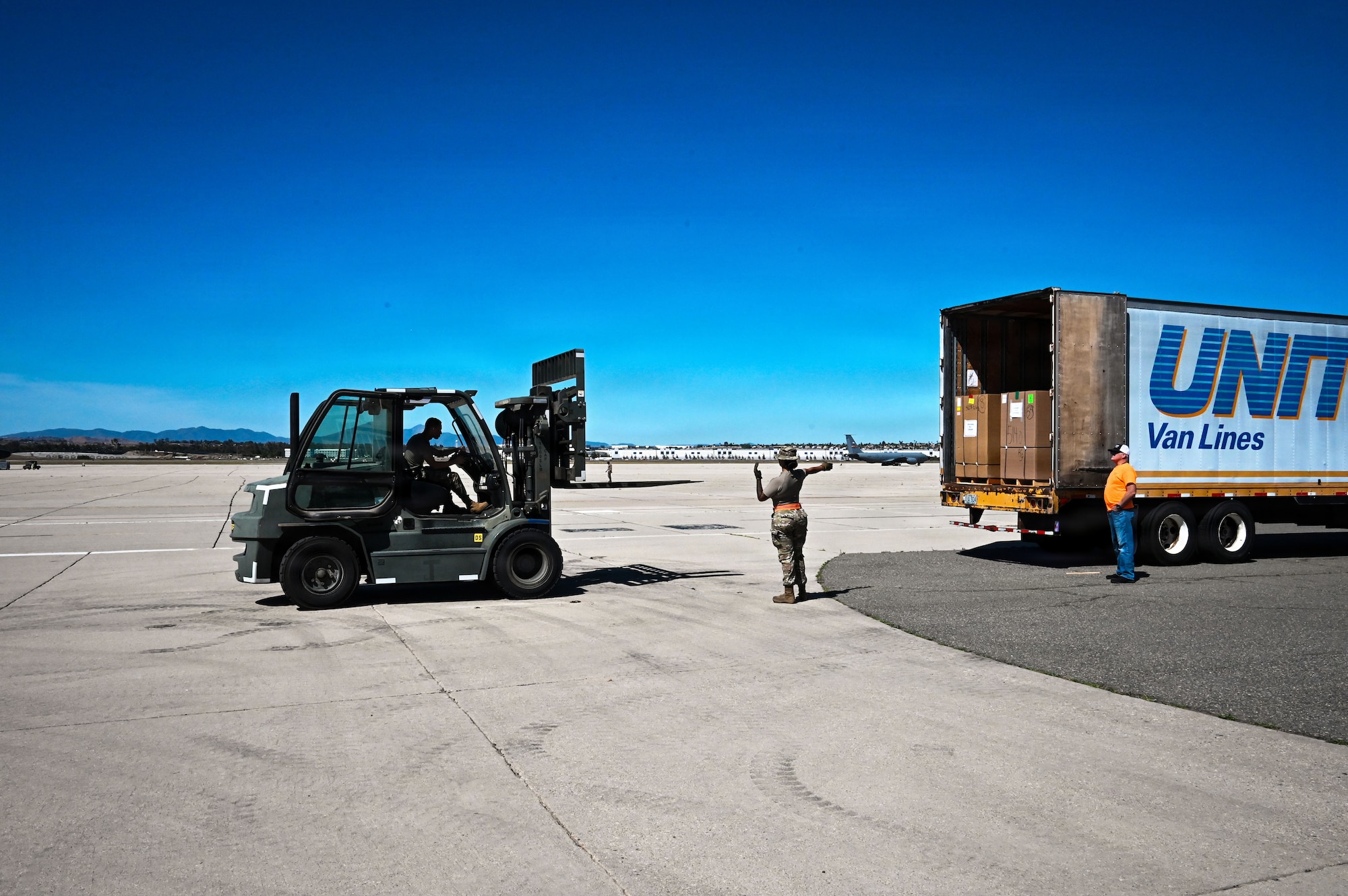 Airman directs delivery truck with cargo