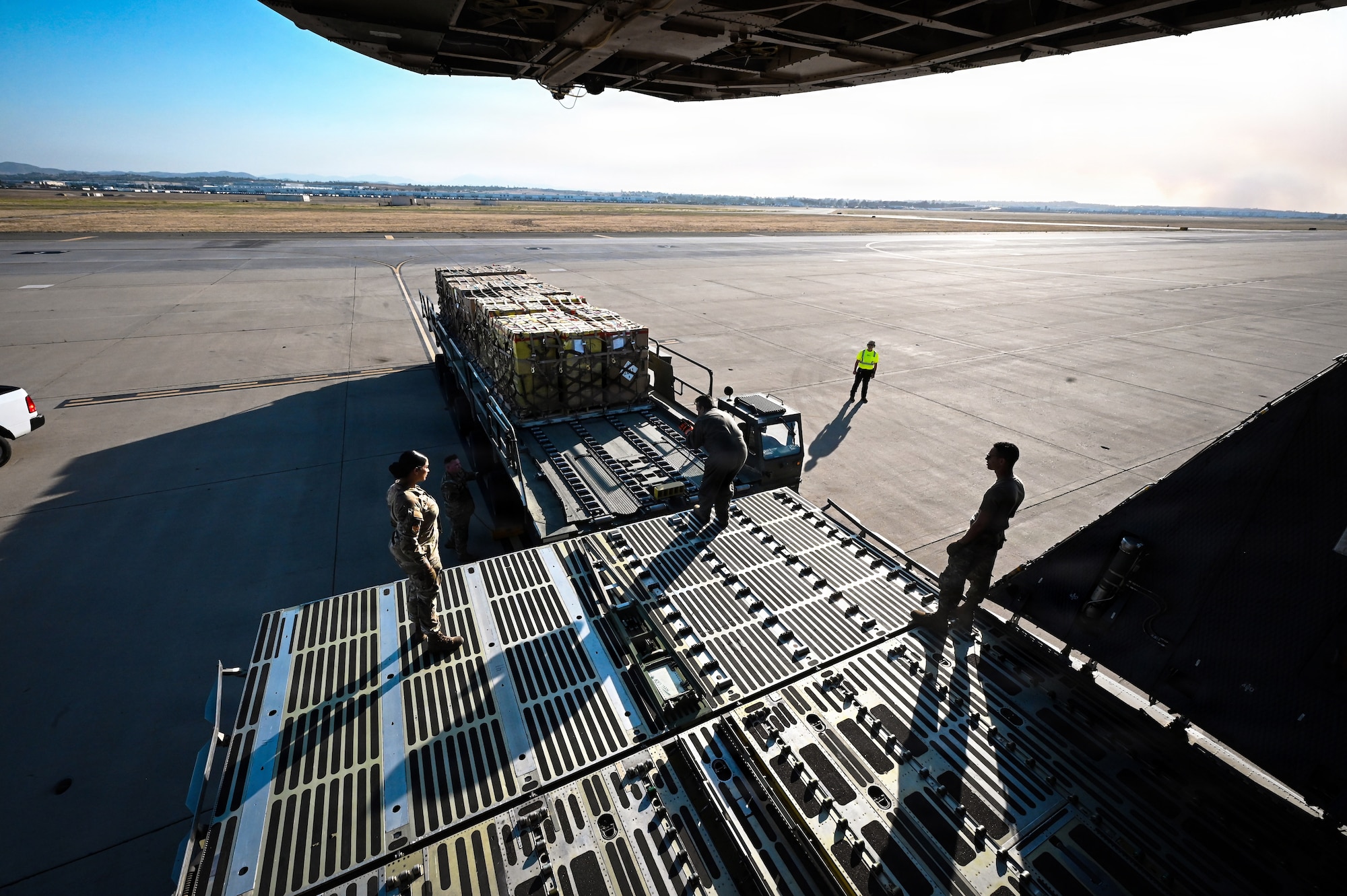 Airmen load cargo onto aircraft
