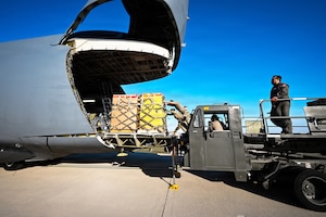 Airmen load cargo onto aircraft