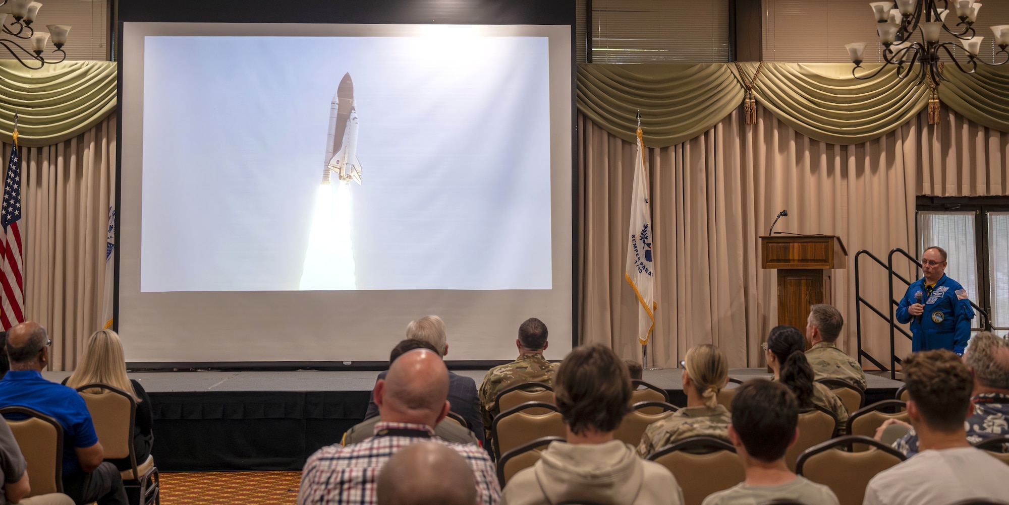 Retired U.S. Air Force Col. and NASA astronaut Michael Fincke speaks about flying as a mission specialist on the Space Shuttle Endeavour at Joint Base McGuire-Dix-Lakehurst, N.J., June 22, 2026. Fincke, who joined the NASA astronaut corps in 1996 and has accumulated 549 days in space, brought his decades of military and spaceflight experience to the installation, speaking to both joint base personnel and their children during his visit. (U.S. Air Force photo by Susan Moriarty)